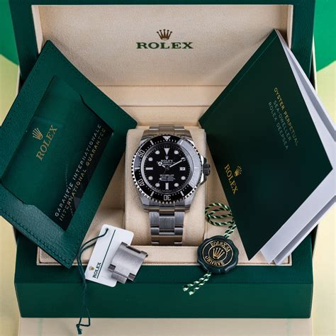 rolex watch box and papers.